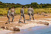 People enjoy a mud bath in Espalmador, a small island located in the North of Formentera, Balearic Islands, Spain