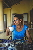 Young attractive woman having breakfast in The Dutch House hotel, Galle, Sri Lanka