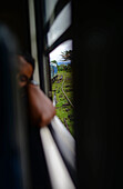 Man sleeping during train ride from Kandy to Nuwara Eliya, Sri Lanka
