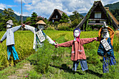 Scarecrows in front of traditional Gassho-Zukuri thatched wooden farmhouses in Shirakawa-go village, Gifu Prefecture, Japan