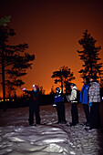 Snowshoeing at sunset through wilderness of Rovaniemi, with Safartica.