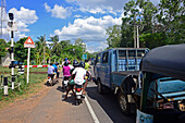Vehicles waiting at train crossing, Sri Lanka