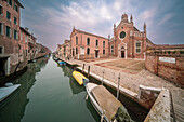 A serene morning at the Church of Madonna dell’Orto, nestled in the heart of Cannaregio, Venice, with calm waters reflecting the architectural marvel.