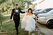 Smiling bride and groom walking outdoors