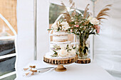 Wedding cake and bouquet on table