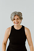 Studio shot of smiling woman in black tank top
