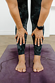 Close-up of woman practicing yoga on exercise mat