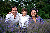 Portrait of smiling family with son (8-9) in lavender field
