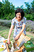 Woman arranging picnic basket in lavender field