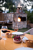 Wine and grapes on table in garden