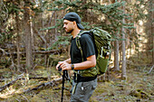 Canada, Yukon, Whitehorse, Man hiking in forest