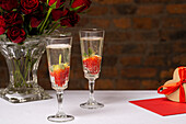 Champagne flutesÊand Valentines Day decorations on table