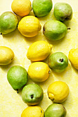 Overhead view of lemons and pears on yellow table cloth