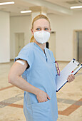 Austria, Vienna, Nurse in face mask with adhesive bandage on arm