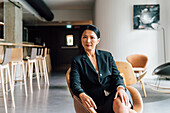 Italien, Porträt einer Geschäftsfrau, die in einem Kreativstudio sitzt