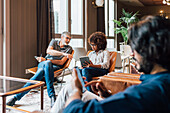 Italy, Business people having meeting in creative studio