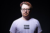 Studio portrait of man wearing eyeglasses and white t-shirt