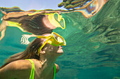 Spain, Mallorca, Woman in scuba mask diving in sea