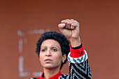 Italy, Tuscany, Pistoia, Woman raising fist