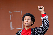 Italy, Tuscany, Pistoia, Woman raising fist