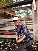 Australia, Melbourne, Portrait of smiling woman working in community garden
