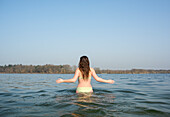 Netherlands, Noord-Brabant, Breda, Rear view of woman walking in lake