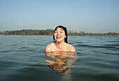 Netherlands, Noord-Brabant, Breda, Woman laughing in lake