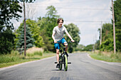 Canada, Ontario, Kingston, Boy (14-15) riding bicycle