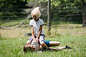 Canada, Ontario, Kingston, Boys (8-9, 14-15) play fighting outdoors