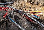 Colorful power cables on dirt