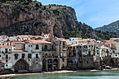 Coastal town with rocky mountain in background, Sicily, Italy