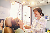 Smiling female doctor and patient in doctors office