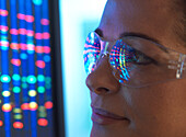 Nahaufnahme eines Wissenschaftlers mit DNA-Sequenzierung, der sich in einer Brille spiegelt