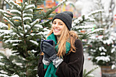 Portrait of woman holding mug at Christmas market