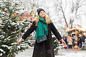 Portrait of smiling woman at Christmas market