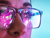 Futuristic reflections in scientists eyeglasses