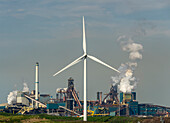 Wind turbine in front of steel mill
