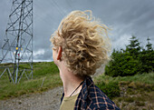 UK, Scotland, Close-up of young blonde man in landscape on windy day