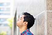 Side view of man puffing up cheeks