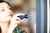 Woman using screwdriver