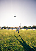 Boy tossing football