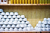 White Cups Stored Upside Down On A Counter In A Restaurant; Barcelona, Spain