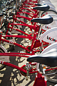 Red Bicycles For Rent Parked In A Row; Barcelona, Spain