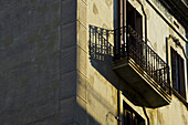 A Balcony On The Side Of A Residential Building In The Sunlight; Barcelona, Spain