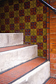 Tile On Steps And Colourful Tile With A Floral Pattern On The Wall; London, England