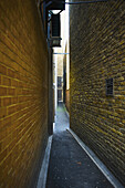 A Narrow Alley Between Two Brick Walls; London, England