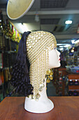 An Ornate Hat And Hair Extensions Displayed On A Mannequin Head In A Shop; London, England