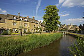 A Residential Building And Water, Lower Slaughter Village, The Cotswolds; Gloucestershire, England
