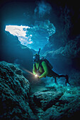 Diving Into One Of The Underwater Caves That Surround Niue; Niue Island
