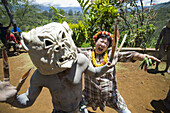 Japanische Frau nimmt an einer Aufführung der Goroka Mudmen teil; Goroka, östliches Hochland, Papua-Neuguinea.